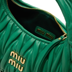 Miu Miu Wander Matelass&eacute; Crossbody Bag in Mango, open top view showing green quilted leather interior and gold-tone logo hardware