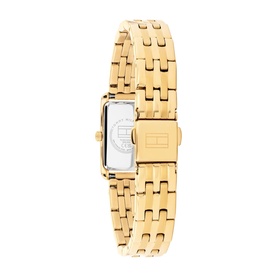 Tommy Hilfiger watch in gold tone with white rectangular dial, shown from rear angle highlighting gold-tone link bracelet and clasp.