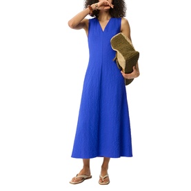 Model wearing Whistles blue sleeveless V-neck midi dress, styled with tan strappy sandals and a woven straw clutch bag.