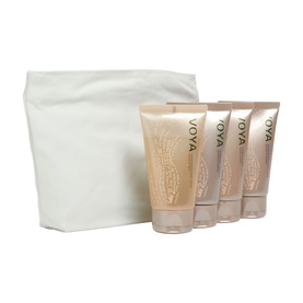 Voya bodycare gift set with four gold tubes and white fabric pouch bag