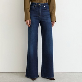 Model wearing Reiss dark blue wide-leg jeans with high waist, styled with a tan top