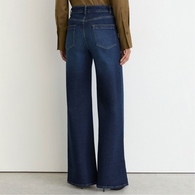 Model wearing Reiss dark blue wide-leg jeans, rear view, styled with an olive blazer