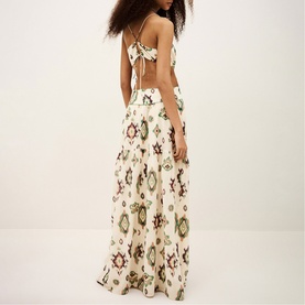 Model wearing Bash cream geometric print maxi dress with open back tie detail and wide-leg silhouette, back view