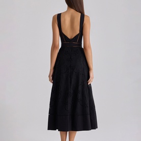 Model wearing House of CB black midi dress with deep V back, lace panelling, and A-line skirt, shown from behind