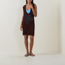 Model wearing Bond Eye walnut knit cover-up dress over blue bikini top, styled with tan flat sandals