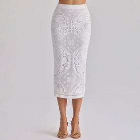 Model wearing House of CB white midi pencil skirt with broderie anglaise floral detail, styled with nude heeled sandals