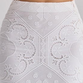 House of CB white broderie anglaise mini skirt, close-up showing intricate floral cutwork embroidery detail