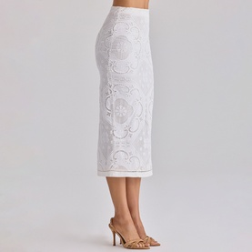Model wearing House of CB white midi skirt with floral broderie lace detail, styled with nude heeled mules