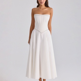 Model wearing House of CB white strapless corset-bodice midi dress with A-line skirt, styled simply against a plain background