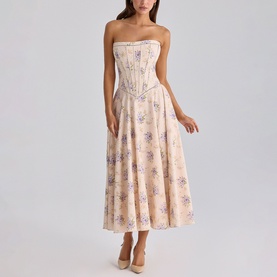 Model wearing House of CB strapless midi dress in Ivory Sweet Peony with floral print, boned corset bodice, and full skirt