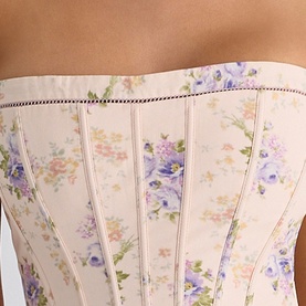 Model wearing House of CB Ivory Sweet Peony floral corset top, close-up detail showing boned panels and delicate pink and purple floral print.