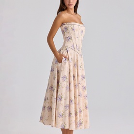 Model wearing House of CB strapless midi dress in Ivory Sweet Peony floral print, with fitted corset bodice and full pleated skirt