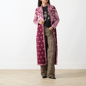 Model wearing Hayley Menzies Dalton Bandana Print Duster Cardigan in burgundy, maxi length with fringe trim, styled with leopard print trousers.