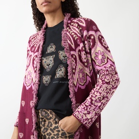 Model wearing Hayley Menzies Dalton Bandana Print Duster Cardigan in burgundy with pink paisley print and fringe trim detail.