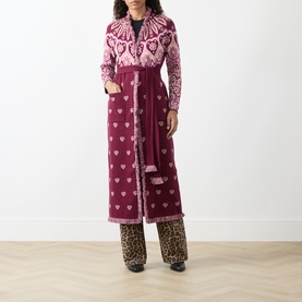 Model wearing Hayley Menzies Dalton Bandana Print Duster Cardigan in burgundy, maxi length with fringe trim and self-tie belt, styled with leopard