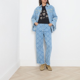 Model wearing Hayley Menzies blue cotton wide-leg jeans with diamond pattern, styled with matching denim jacket and black graphic tee.