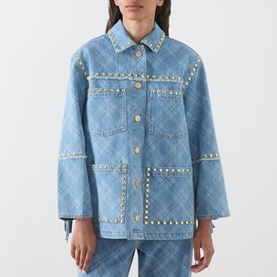 Model wearing Hayley Menzies blue denim jacket with gold stud trim, argyle pattern, oversized fit, styled with matching blue denim trousers