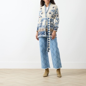 Model wearing Hayley Menzies Nandita Jacquard Wrap Cardigan in blue with elephant and palm print, fringe shawl collar, styled with light blue