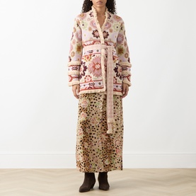 Model wearing Hayley Menzies ecru cotton floral intarsia knit cardigan, styled with a printed midi skirt and brown boots.