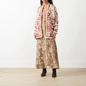 Model wearing Hayley Menzies ecru cotton knit cardigan with pink floral pattern, styled with leopard-print maxi dress and brown ankle boots