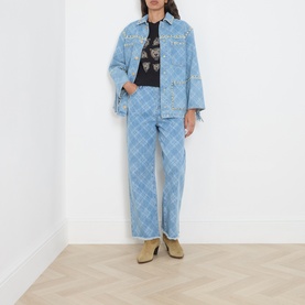Model wearing Hayley Menzies black cotton T-shirt, styled with light blue argyle denim jacket and matching wide-leg jeans, tan suede boots.
