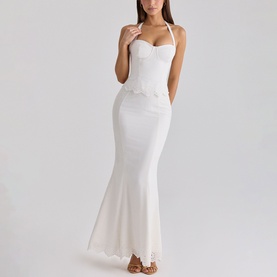 Model wearing House of CB white halterneck maxi dress with sweetheart bodice and mermaid hem silhouette