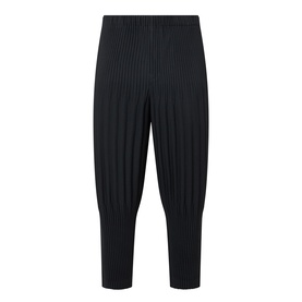 Issey Miyake Basic Keshi Pleated Trousers in black with all-over pleating, tapered leg, and elasticated waistband