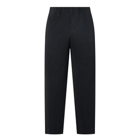 Issey Miyake Pleated Wide Leg Trousers in black with vertical pleating, elasticated waist, and relaxed wide-leg silhouette.