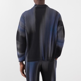 Model wearing Issey Miyake Gradient Pleated T-Shirt in blue, back view, with high neck, dropped shoulders and pleated abstract stripe pattern.