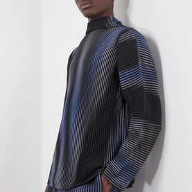 Model wearing Issey Miyake Gradient Pleated T-Shirt in blue with abstract stripe pattern, high neck, dropped shoulders, and long sleeves.