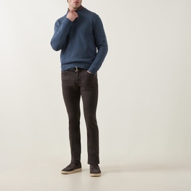 Model wearing Jacob Cohen Bard Straight Leg Jeans in brown, styled with a blue knit jumper and suede loafers.