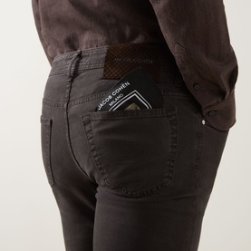 Model wearing Jacob Cohen Bard Straight Leg Jeans in brown, showing rear view with leather logo badge and handkerchief detail at back pocket.