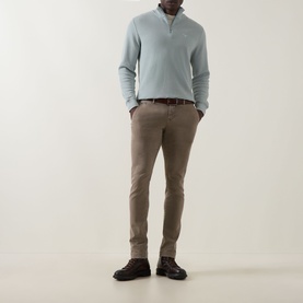 Model wearing Jacob Cohen Bobby Slim Leg Chinos in Elephant Grey with a light blue half-zip knit and dark leather shoes.
