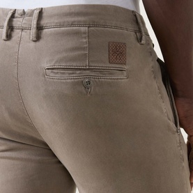 Model wearing Jacob Cohen Bobby Slim Leg Chinos in Elephant Grey, close-up of rear pocket with leather logo patch detail.