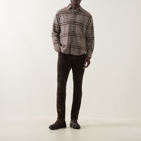 Model wearing Jacob Cohen Bard Corduroy Straight Leg Trousers in brown, styled with grey plaid overshirt and dark lace-up shoes.