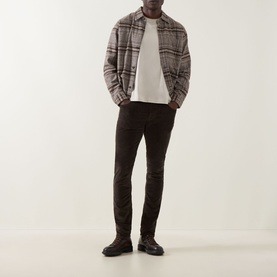 Model wearing Jacob Cohen Bard Corduroy Straight Leg Trousers in brown, styled with a plaid overshirt and white tee.