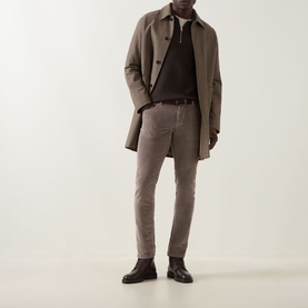 Model wearing Jacob Cohen 3049 Cord Jeans in Elephant Grey, styled with a taupe overcoat, dark knit polo, and black leather shoes.