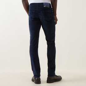 Model wearing Jacob Cohen Bard Corduroy Straight Leg Trousers in Night Blue, rear view showing leather logo patch and five-pocket style
