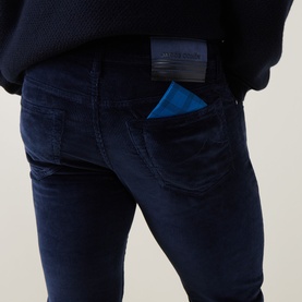 Model wearing Jacob Cohen Bard Corduroy Straight Leg Trousers in Night Blue, rear view showing leather logo patch and five-pocket detail.