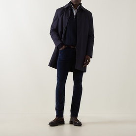 Model wearing Jacob Cohen Bard Corduroy Straight Leg Trousers in Night Blue, styled with a navy overcoat, dark knitwear and brown loafers.