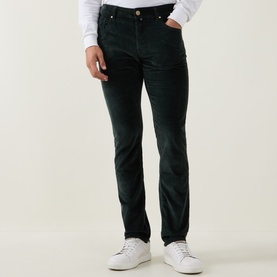 Model wearing Jacob Cohen Bard Corduroy Straight Leg Trousers in T89 Green, styled with a white top and white trainers.