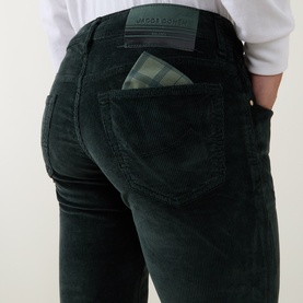 Model wearing Jacob Cohen Bard Corduroy Straight Leg Trousers in green, showing rear logo patch and checked pocket lining detail.