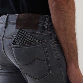 Jacob Cohen 3049 slim jeans in medium black denim, rear view showing signature patch detail and back pocket with branded card holder.