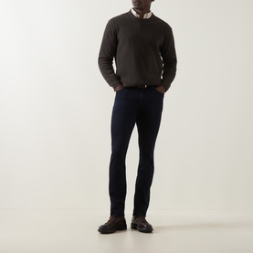 Model wearing Jacob Cohen 3049 Slim Jeans in Dark Blue, styled with a dark brown knit jumper and dark leather shoes.