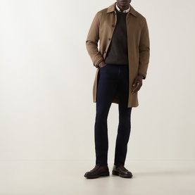Model wearing Jacob Cohen 3049 Slim Jeans in Dark Blue, styled with a camel overcoat, dark knit, and brown leather shoes.