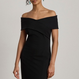Model wearing Lauren black off-shoulder bodycon dress with crossover neckline detail, styled with drop earrings