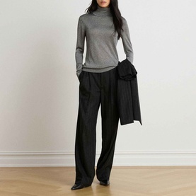 Model wearing Lauren Black/Silver metallic roll-neck knit with wide-leg black trousers and a draped black blazer.