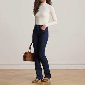 Model wearing Lauren Mascarpone Cream turtleneck knit top with dark indigo bootcut jeans and nude heels, carrying tan leather bag