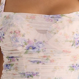 House of CB Ivory Peony Print ruched mesh fabric detail, showing delicate purple and pink floral pattern with sheer overlay texture.