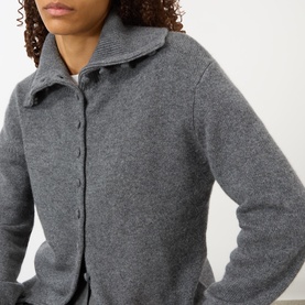 Model wearing Lisa Yang The Denie Knit Cardigan in Graphite, featuring flat extended collar and button fastening in 100% cashmere